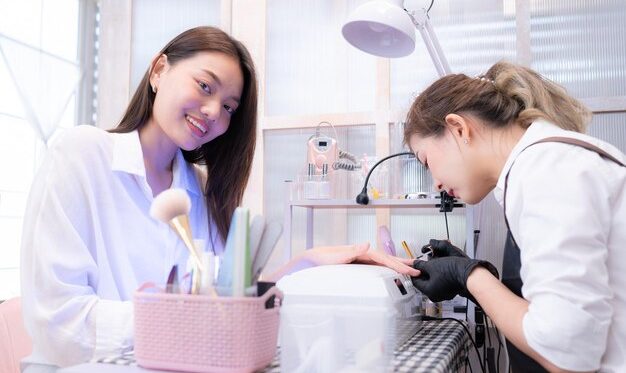 nail-technician-is-painting-nails-customer_159755-15592